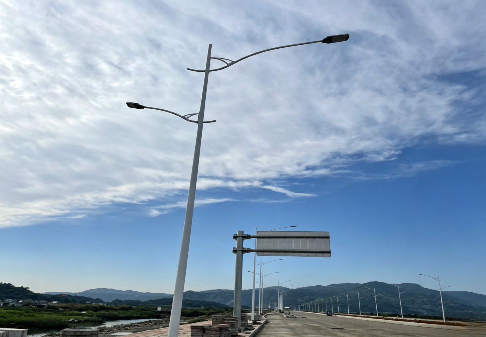 Multi-lane highway with uniform LED street lighting stretching into the distance